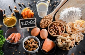 Various allergens on a table top. fruit, dairy, shellfish